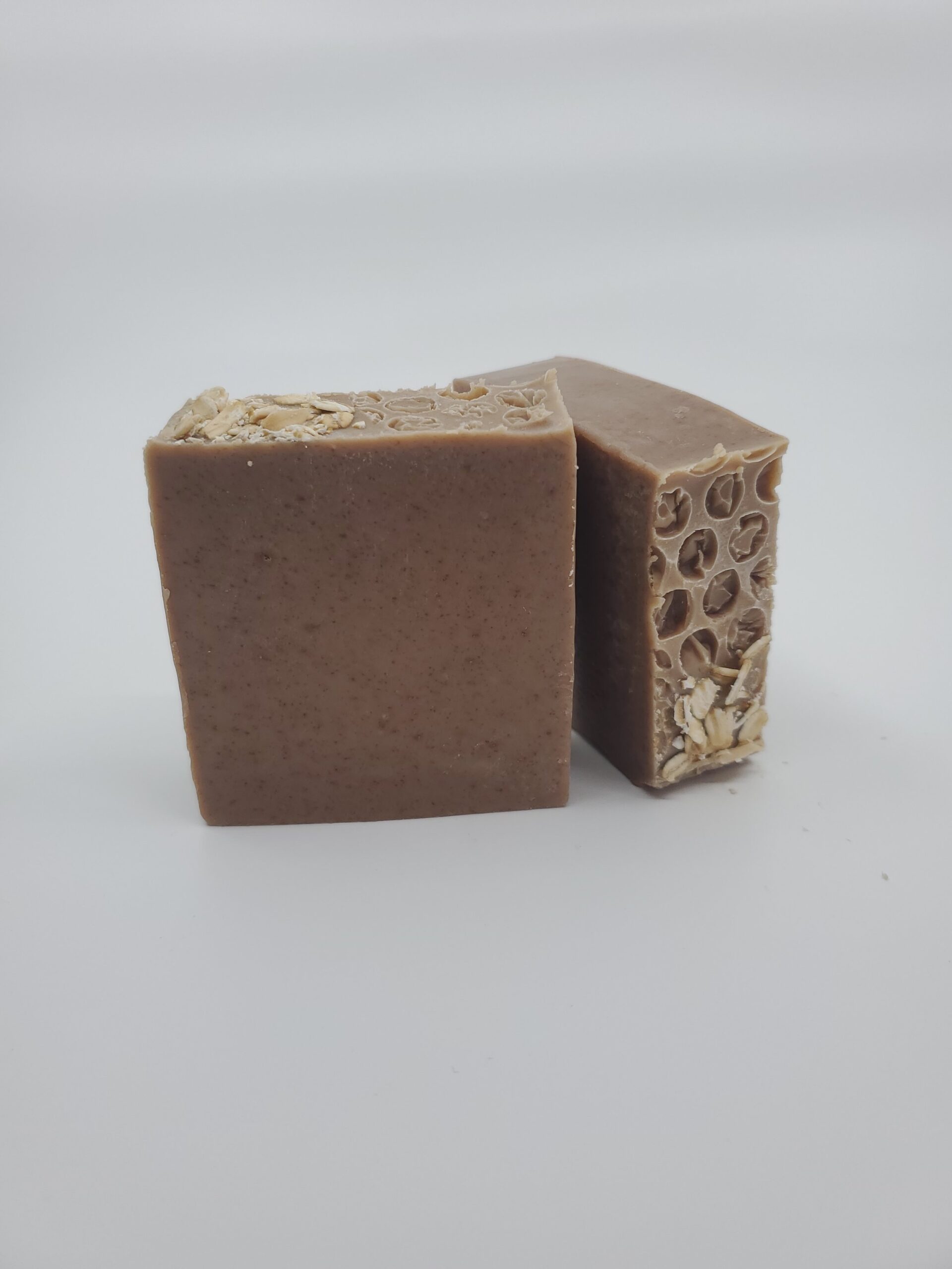 Natural handmade soap with oatmeal, showcasing a smooth texture and earthy brown color, ideal for gentle cleansing and exfoliation.